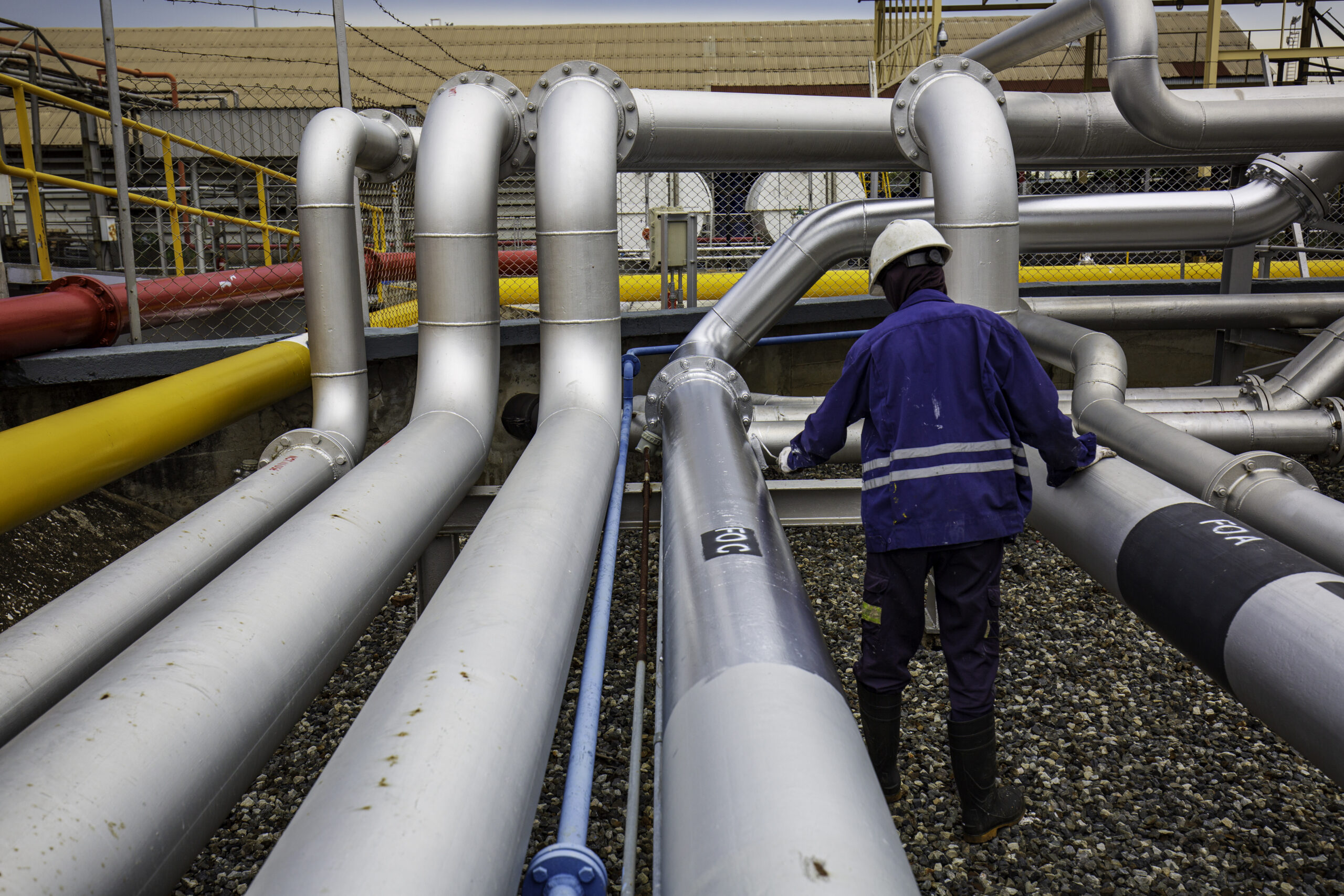 male worker painted gray at pipeline oil